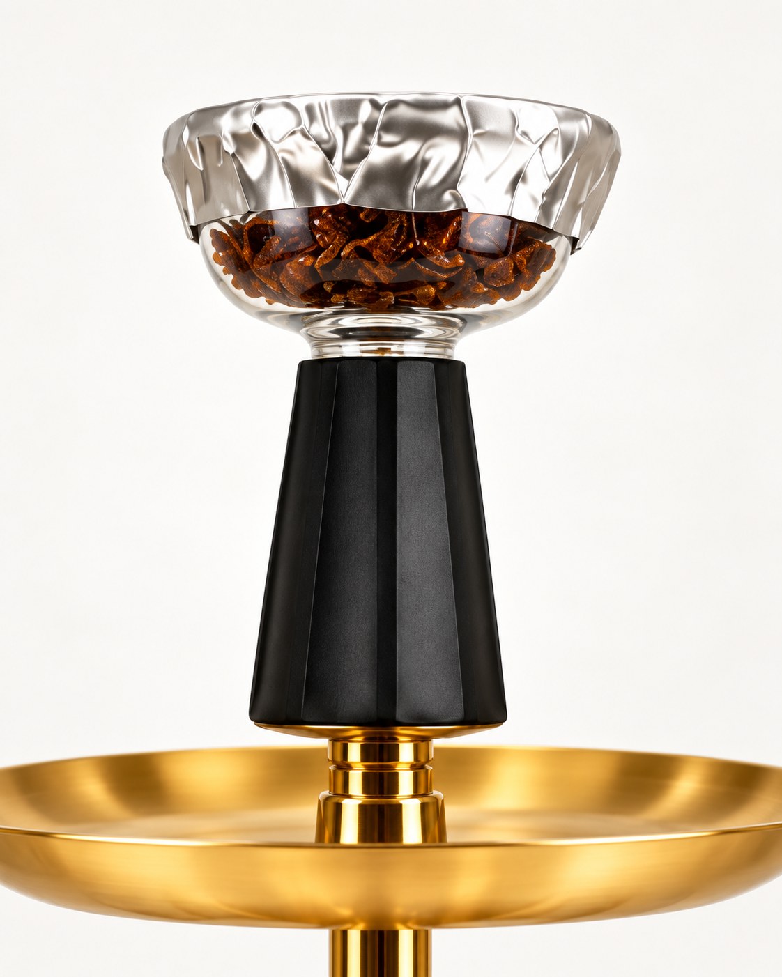 Clear Pyrex bowl filled with tobacco on a black mount.