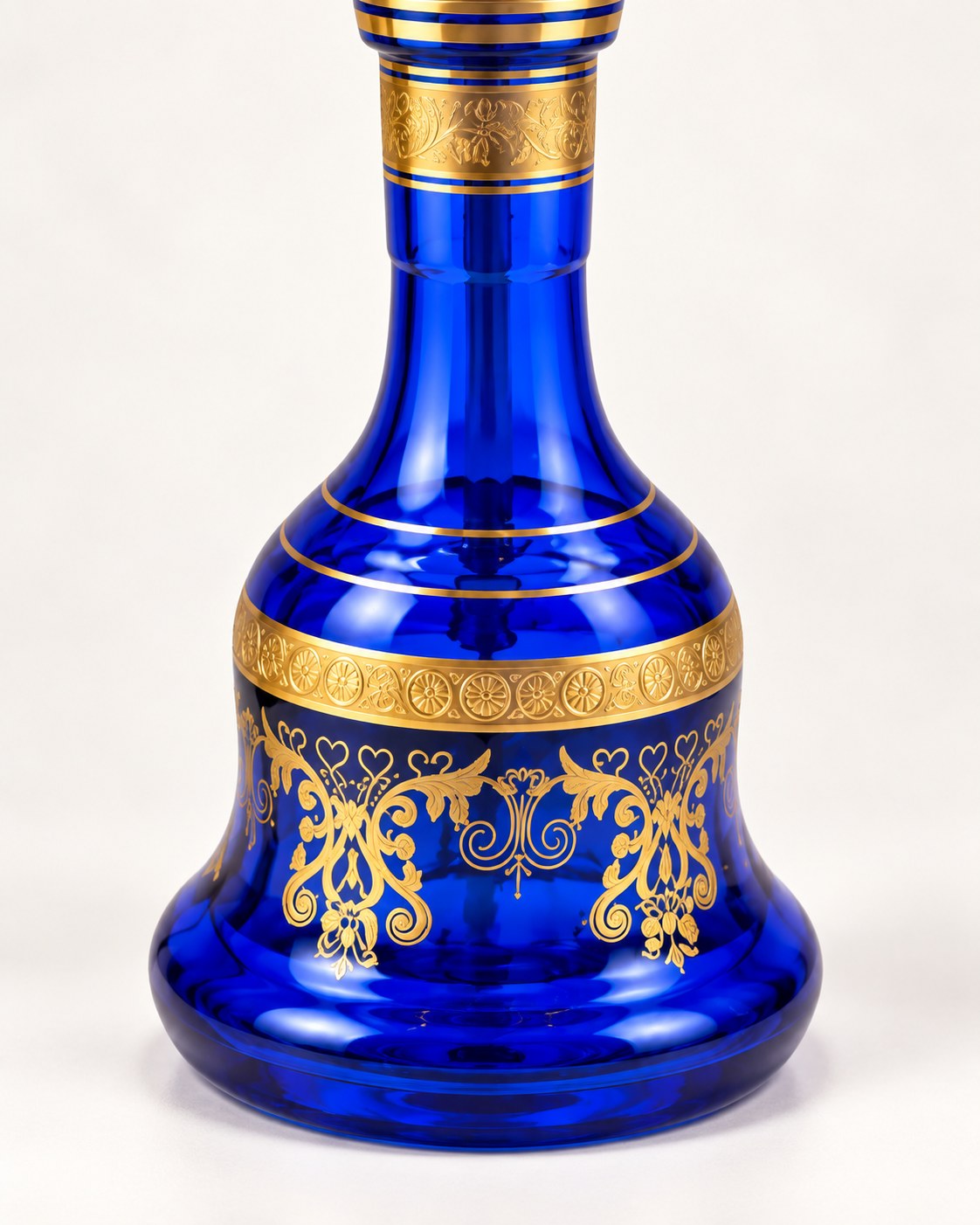 Cobalt blue glass base with gold bands and arabesques.